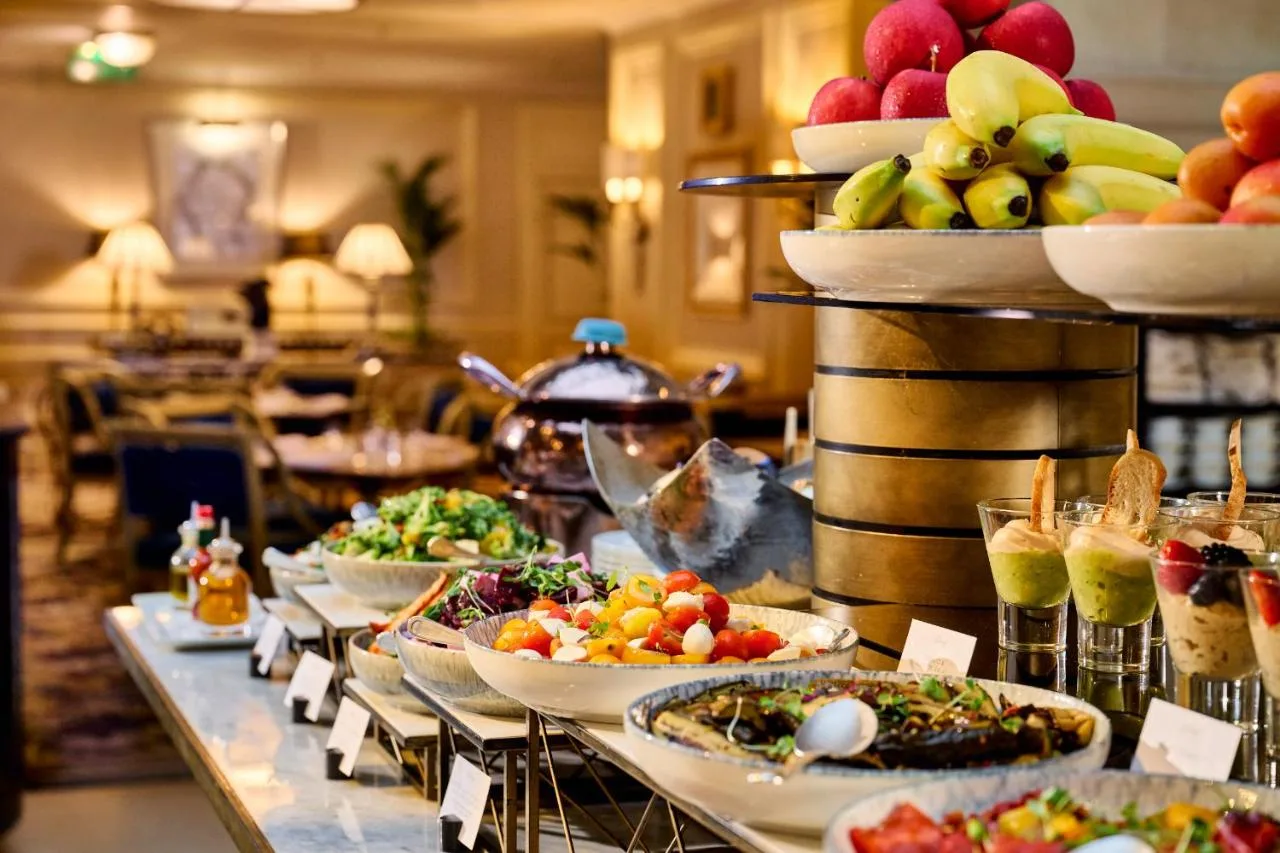 Buffet line with plates of food at The Landmark London
