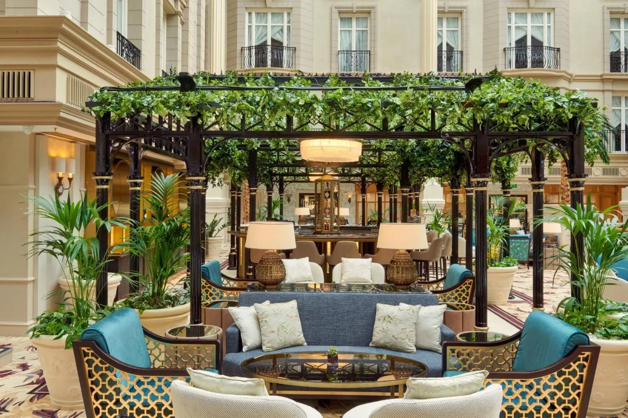 Lobby lounge with blue couch under a pergola at The Landmark London